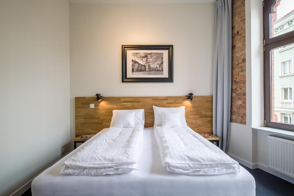 Posteľ alebo postele v izbe v ubytovaní Loft Apartments Poznań