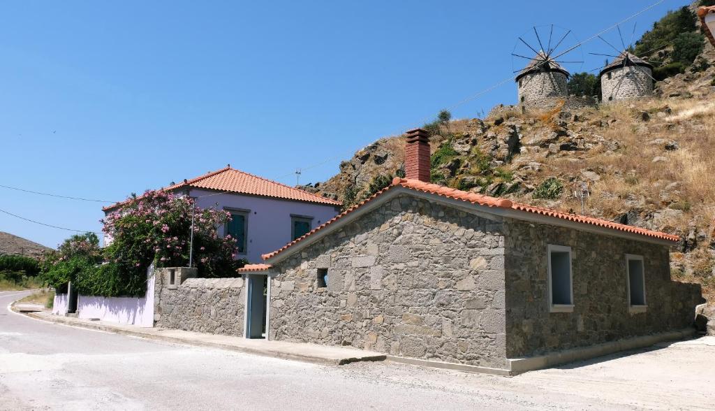 a stone building on the side of a hill at Under the Windmills in Kondiás