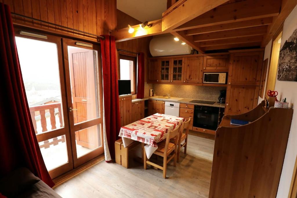 a kitchen with a table with a table cloth on it at Le Duplex d&#39;Aussois in Aussois