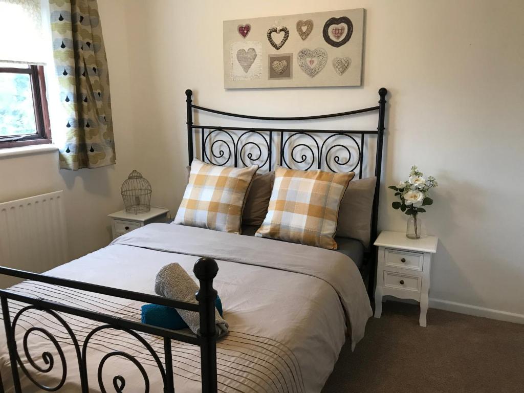 a bedroom with a black bed with two night stands at Swale Corner in Wellingborough