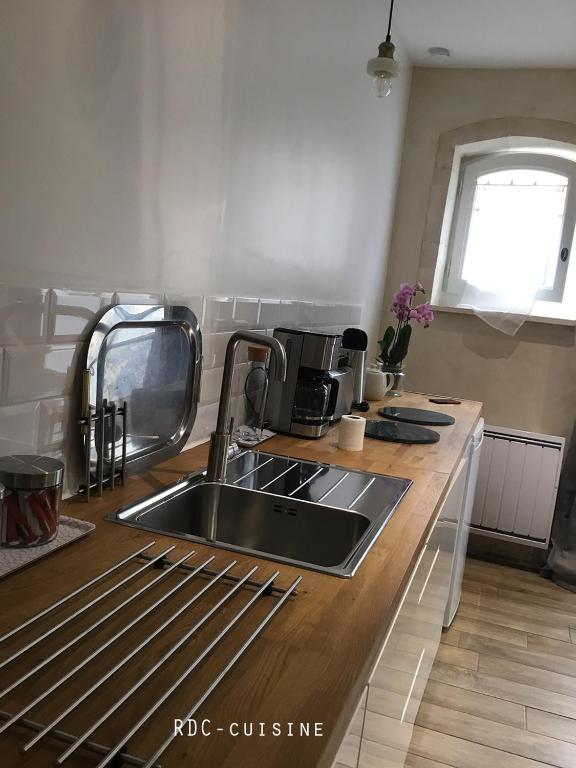 a kitchen with a sink and a counter top at Appartement Arles Centre Historique in Arles