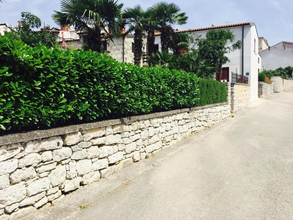 a stone retaining wall next to a street at Villa Marija in Vrsar