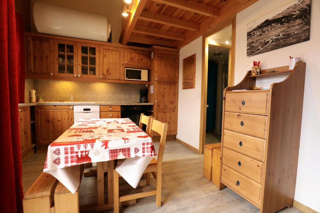 a kitchen with a table with a red and white table cloth at Le Duplex d&#39;Aussois in Aussois