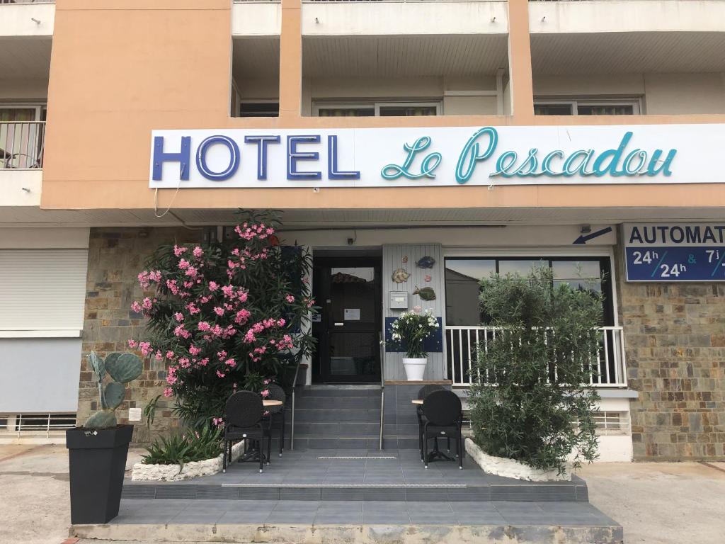 a hotel with a sign on the front of a building at Hôtel Le Pescadou in Argelès-sur-Mer