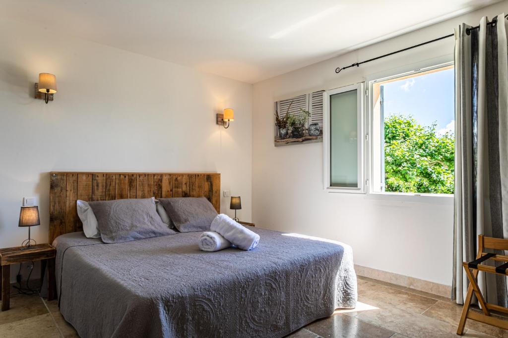 a bedroom with a bed and a window at Mas Saint Julien in Cavaillon
