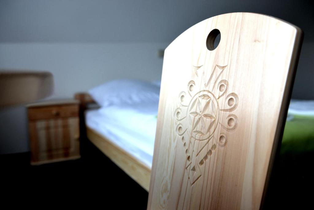 a wooden door in a bedroom with a bed at Noclegi Sucha Woda in Poronin