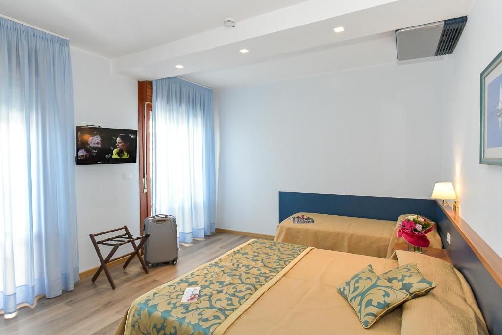 Postel nebo postele na pokoji v ubytování Hotel Souvenir