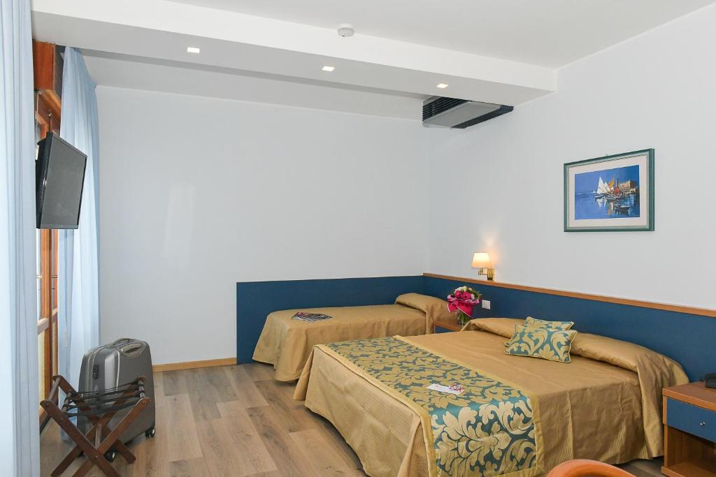 Postel nebo postele na pokoji v ubytování Hotel Souvenir