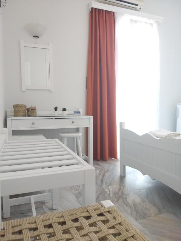 Postel nebo postele na pokoji v ubytování Syrianos Hotel