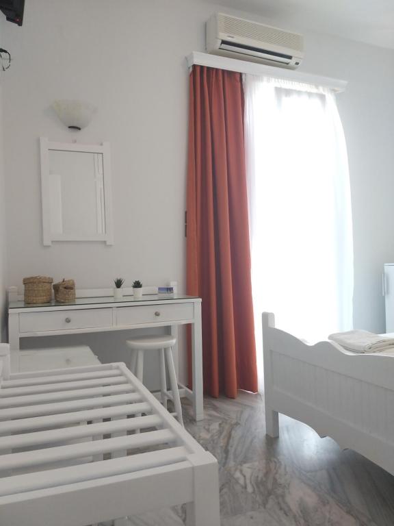 Postel nebo postele na pokoji v ubytování Syrianos Hotel