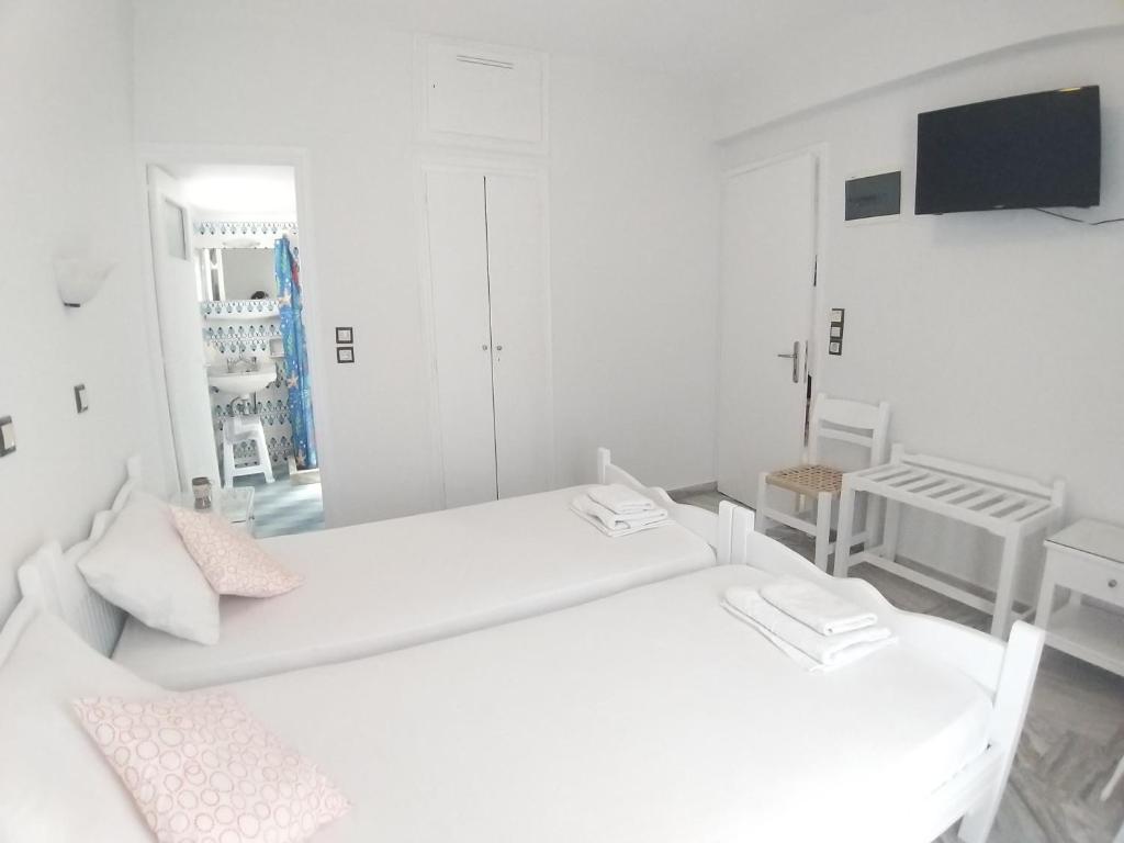Postel nebo postele na pokoji v ubytování Syrianos Hotel