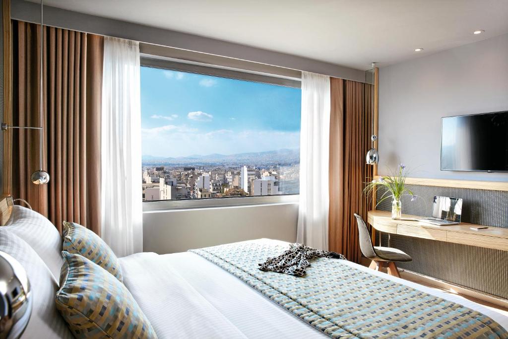 Postel nebo postele na pokoji v ubytování Wyndham Grand Athens