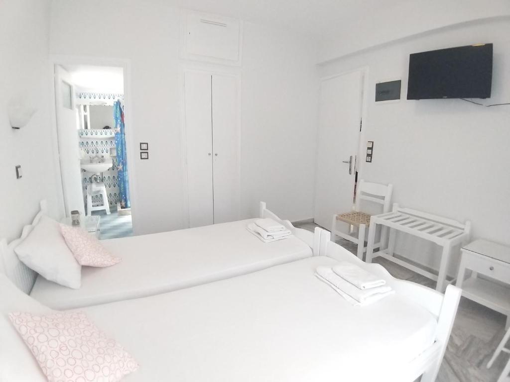 Postel nebo postele na pokoji v ubytování Syrianos Hotel