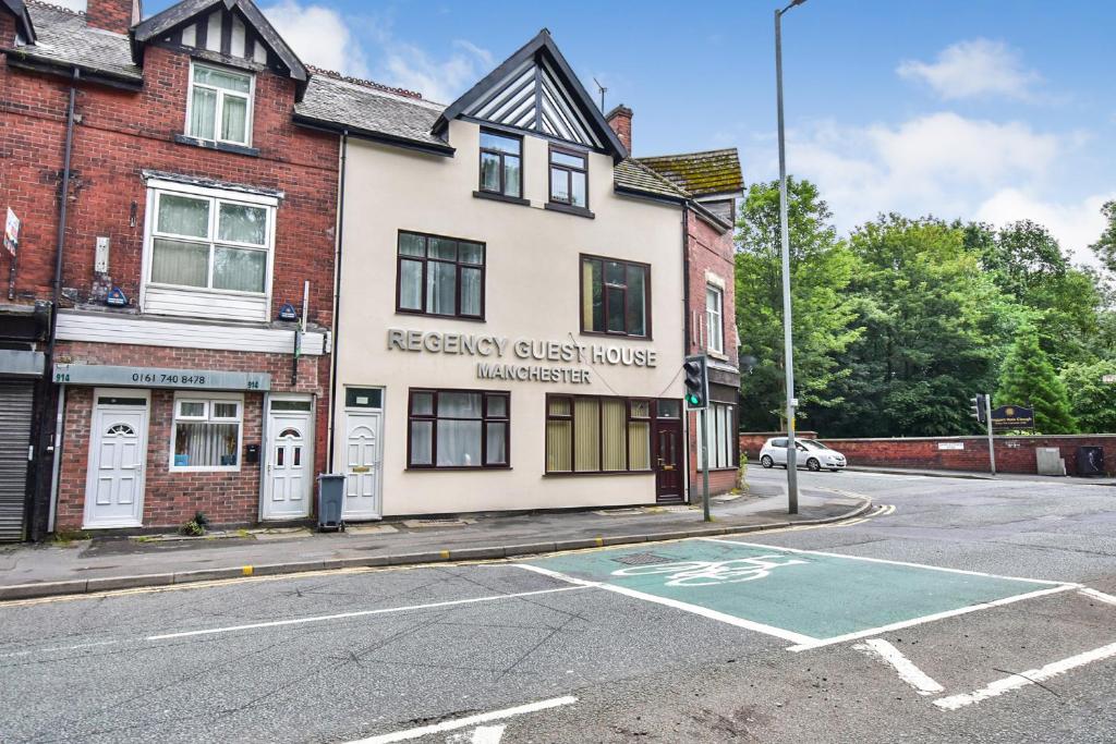 a building on the corner of a street at Regency GuestHouse Manchester North in Manchester