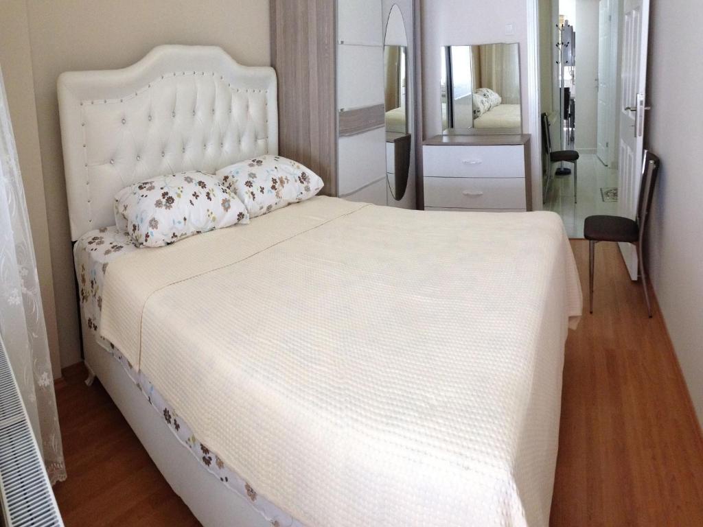 イスタンブールにあるYilmaz Apartの鏡付きのベッドルームの白いベッド1台