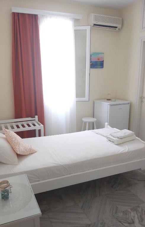 Postel nebo postele na pokoji v ubytování Syrianos Hotel