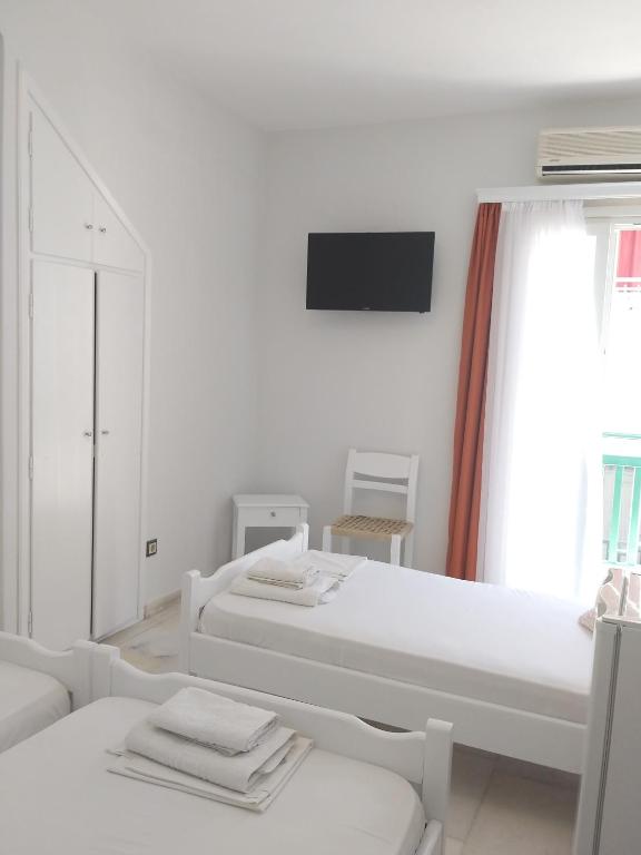Postel nebo postele na pokoji v ubytování Syrianos Hotel