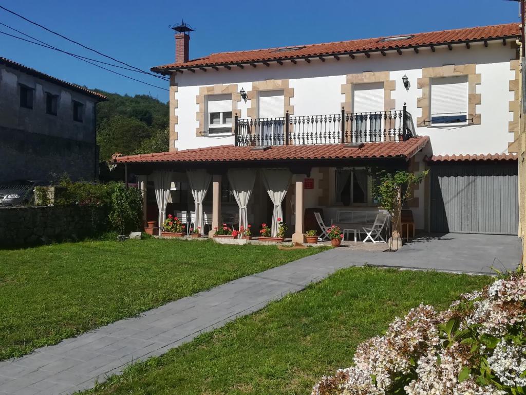 a house with a balcony and a driveway at Casa Rural La Rasilla in Castillo-Pedroso
