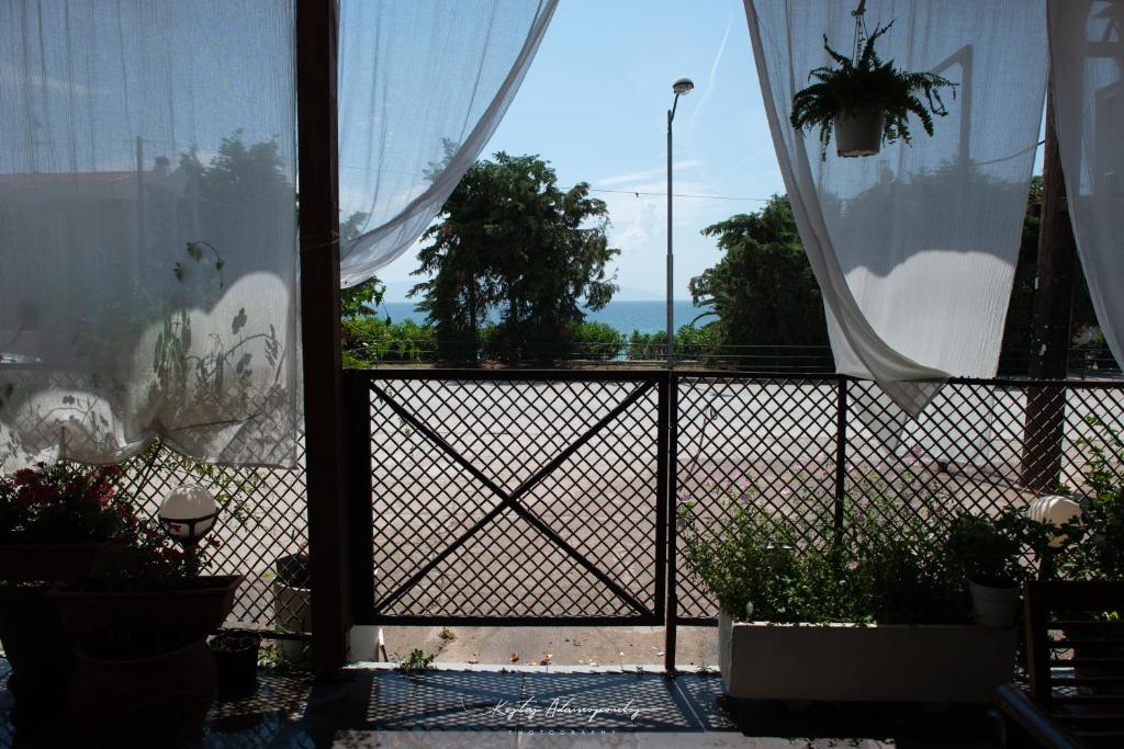 a gate with a view of the ocean from a house at Premier Sea Apartment in Paleo Tsifliki