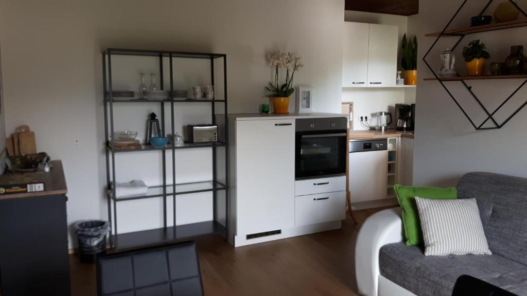 Elle comprend une petite cuisine équipée d'un réfrigérateur blanc et d'un canapé. dans l'établissement Haus Gertrude Hörack, à Sankt Wolfgang im Salzkammergut