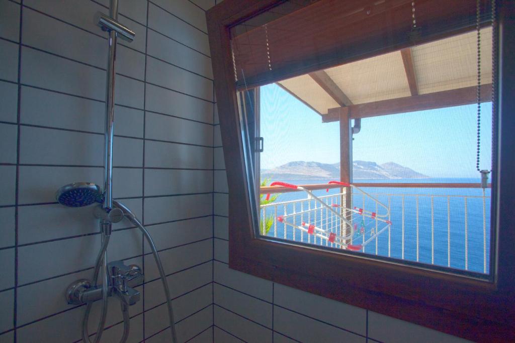 a shower with a window and a view of the water at Sunset Villa Hotel in Kaş