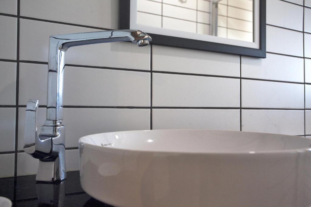 a white sink in a bathroom with a faucet at Sunset Villa Hotel in Kaş