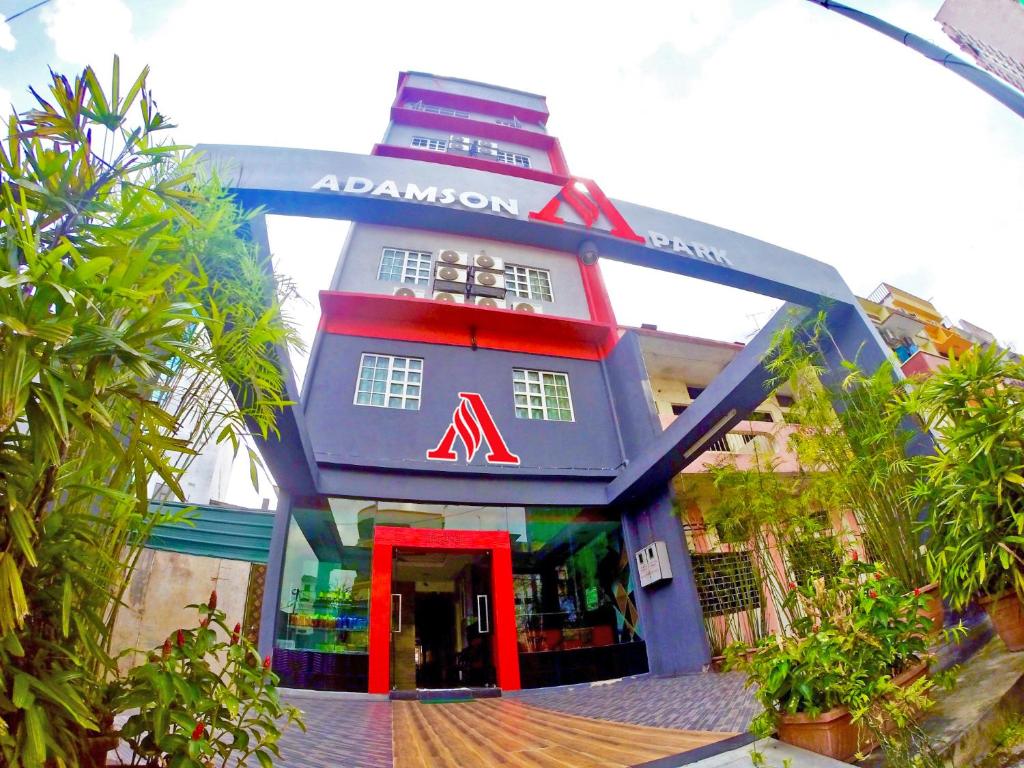 a blue and red building with a red door at Adamson Park Kuala Lumpur in Kuala Lumpur