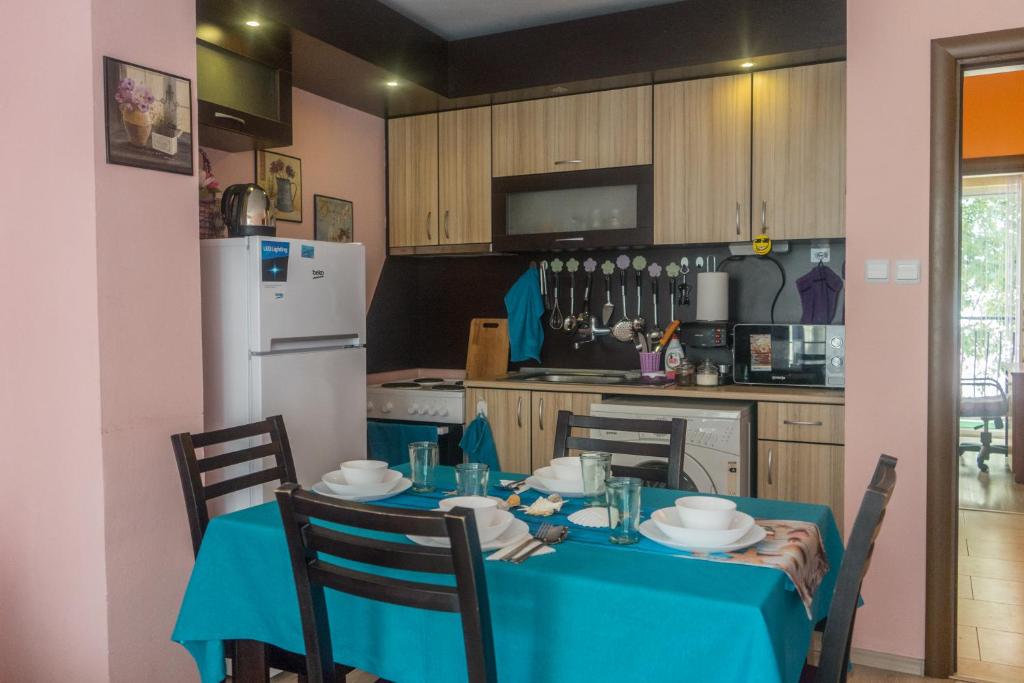 eine Küche mit einem Tisch und einem blauen Tischtuch in der Unterkunft Apartment Eve in Warna