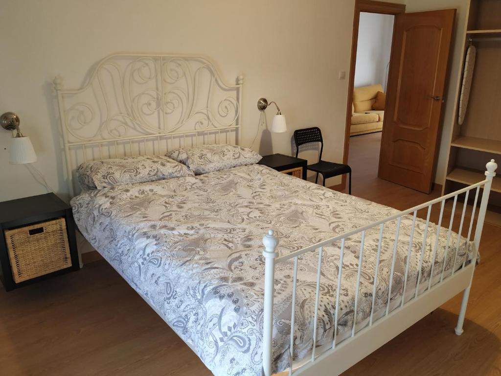 a bedroom with a bed with a white bed frame at Apartamento CUATTRO vut 47-169 wifi in Valladolid