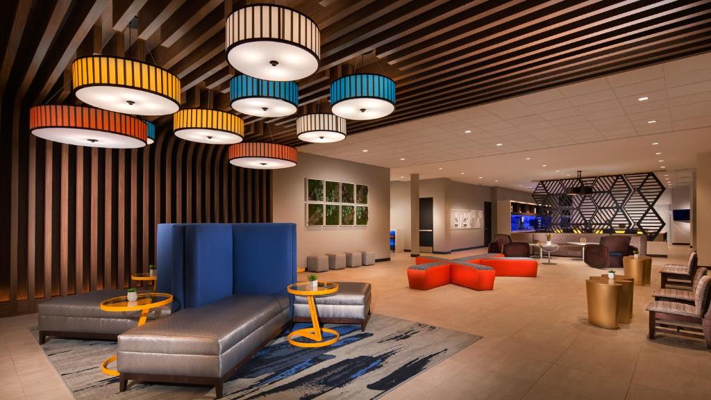a lobby with couches and chairs and lights at GLō Best Western Nashville in Nashville