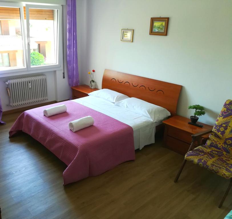 a bedroom with a large bed with a pink blanket at Venice Amazing House in Marghera