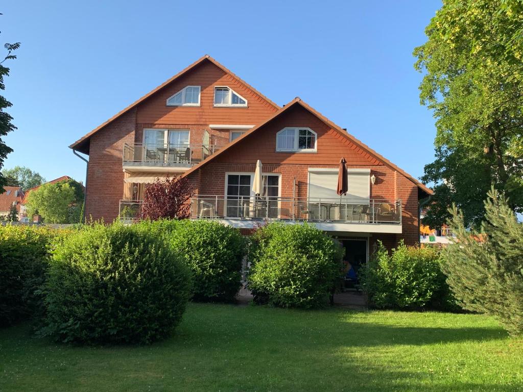 a large brick house with bushes in front of it at Gorch-Fock-Straße 2 in Timmendorfer Strand