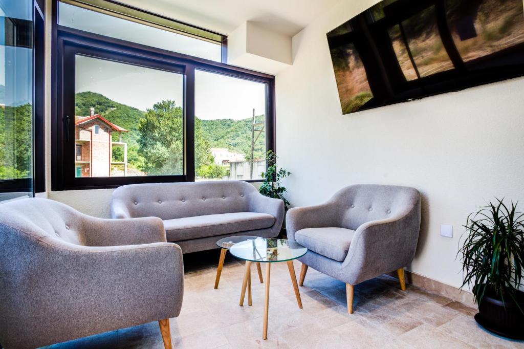 a living room with two chairs and a table at Hotel Odissey Jaz in Budva