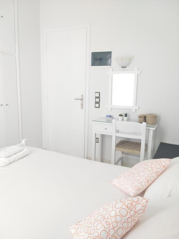 Postel nebo postele na pokoji v ubytování Syrianos Hotel