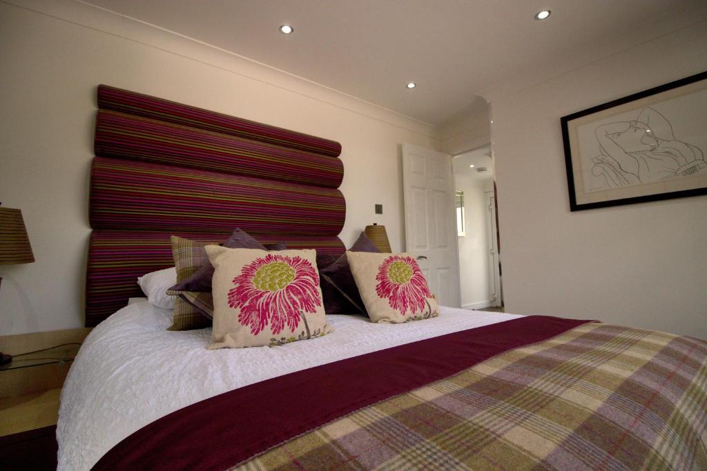 a bedroom with a bed with two pillows on it at The Marlfield in Bellshill