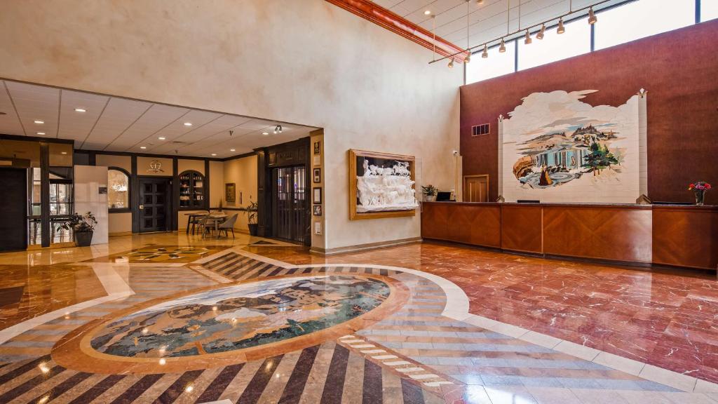 a lobby with a large table in the middle of a room at The Rushmore Hotel & Suites; BW Premier Collection in Rapid City