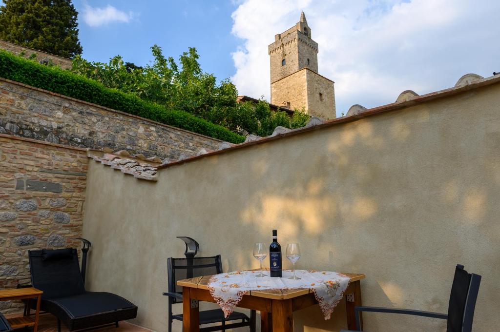 a table with a bottle of wine on top of a wall at CASA DEL MEDIOEVO in San Gimignano