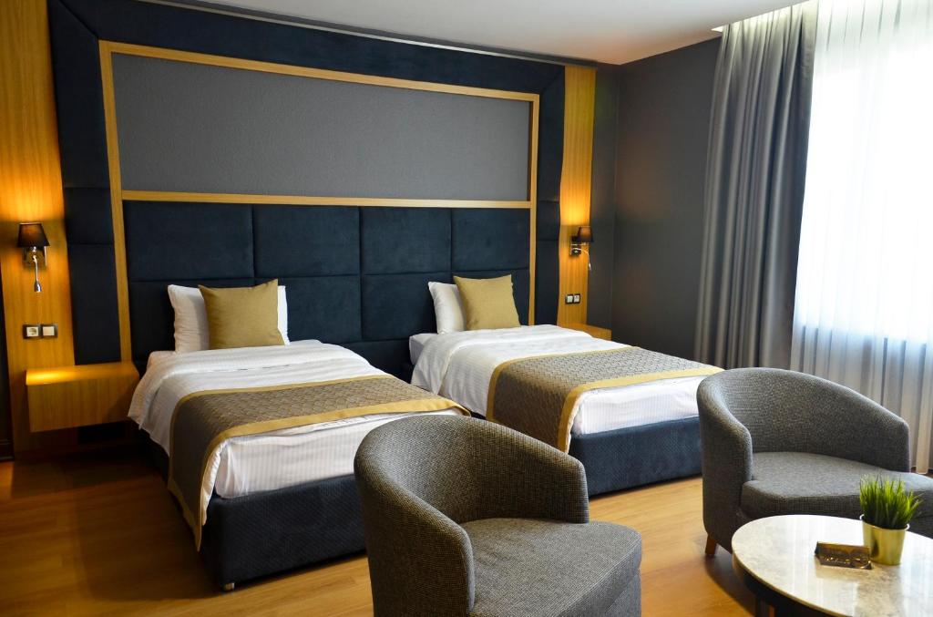 Postel nebo postele na pokoji v ubytování Hotel Konak