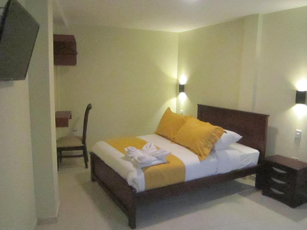 Postel nebo postele na pokoji v ubytování Hostal CañaLimeña
