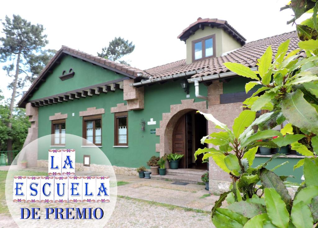 a house with a sign in front of it at La Escuela de Premio in Premió