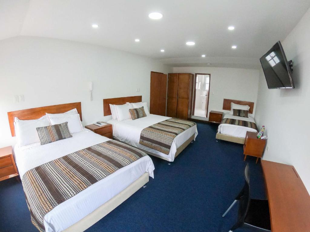 Postel nebo postele na pokoji v ubytování Hotel Estación Sabana