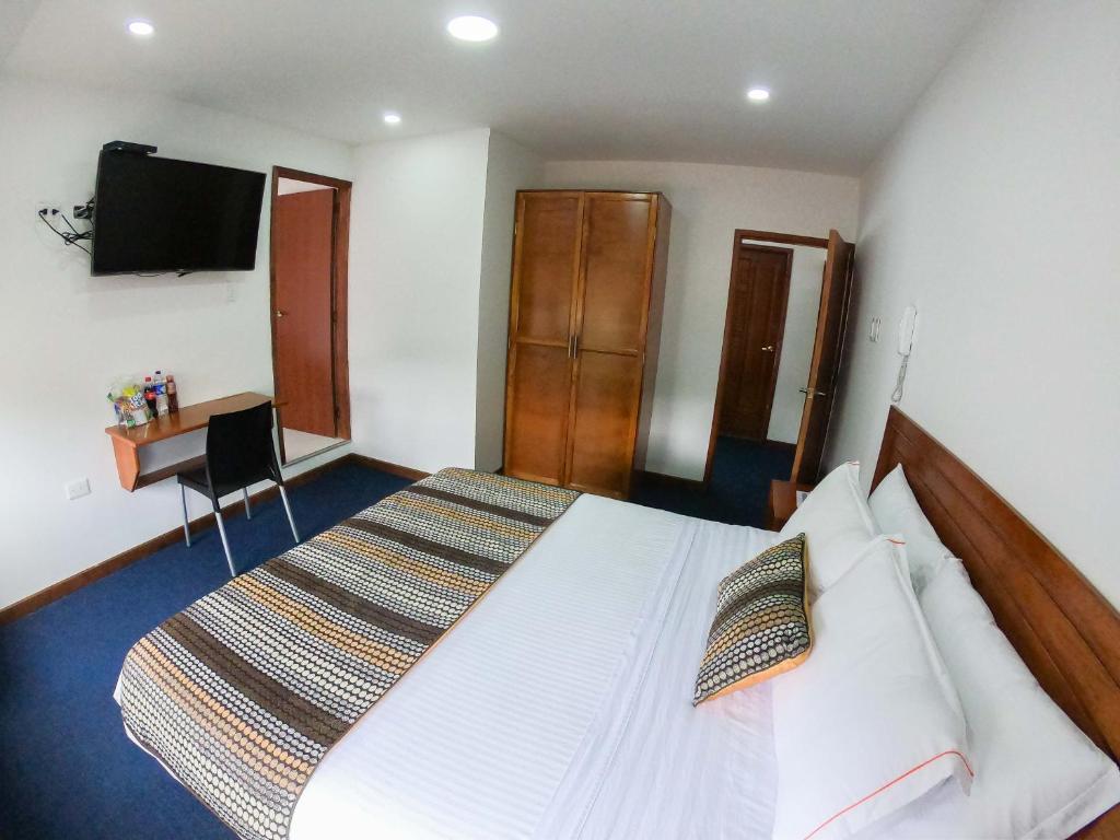 Postel nebo postele na pokoji v ubytování Hotel Estación Sabana