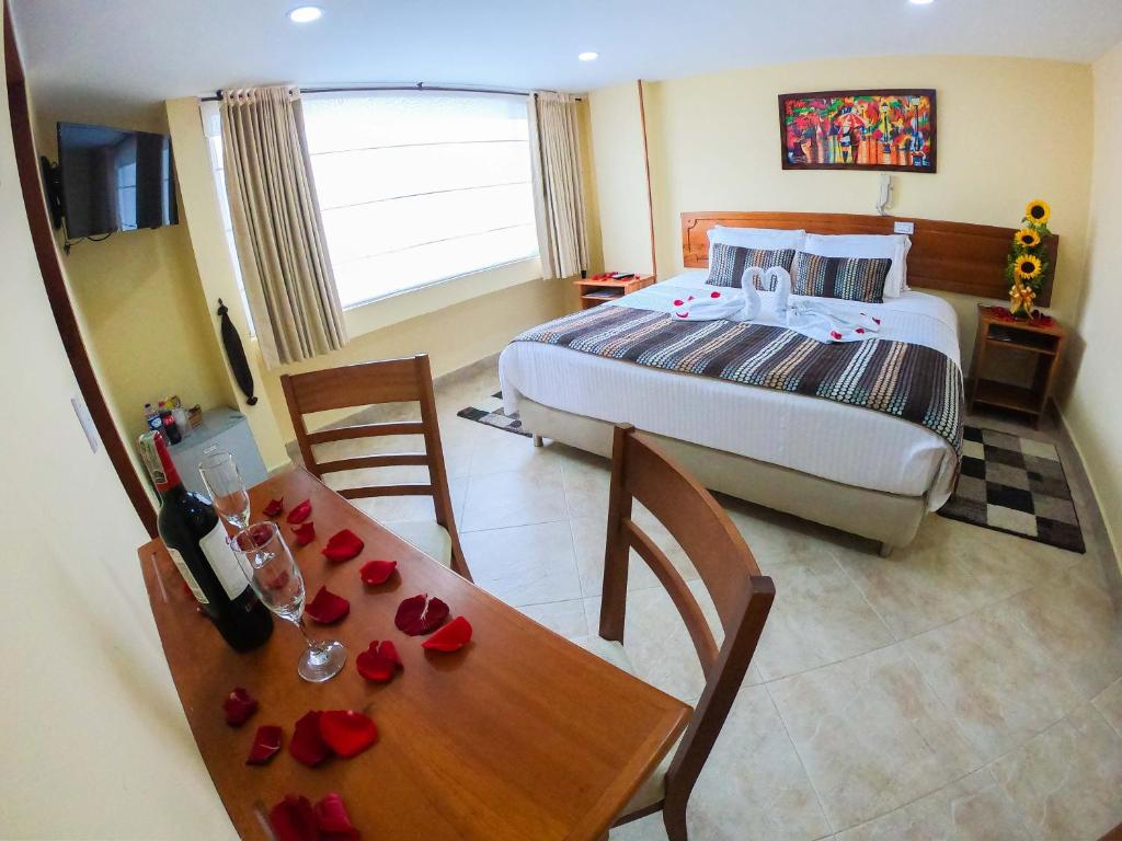 Postel nebo postele na pokoji v ubytování Hotel Estación Sabana