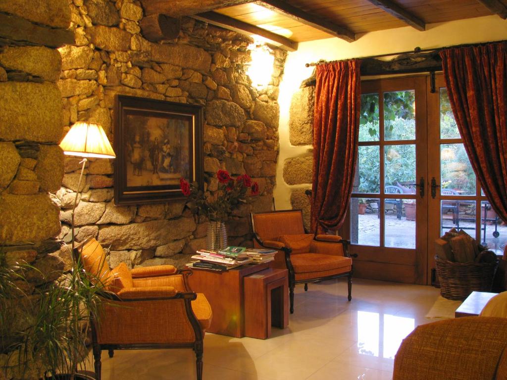 a living room with a stone wall at A Lagosta Perdida in Montezinho