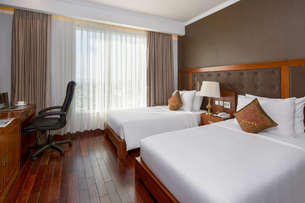 Giường trong phòng chung tại Samdi Da Nang Central Hotel