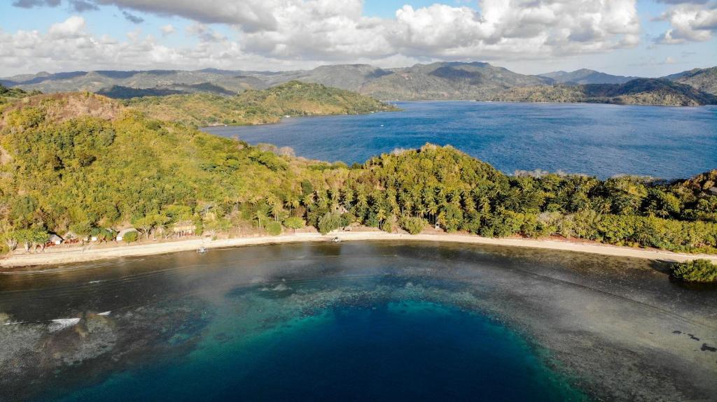 an island in the middle of a body of water at The Papalagi Resort in Gili Gede
