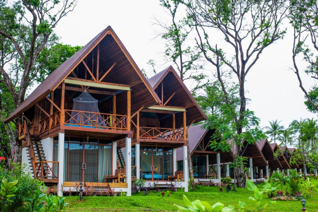 a house in the middle of a forest at Phayamas Private Beach Resort and Island Brew - Adults Only in Ko Phayam