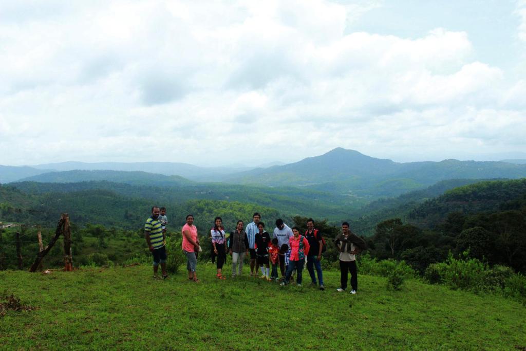 a group of people standing on top of a hill at Vamoose Kaddu Kallu in Kalasa