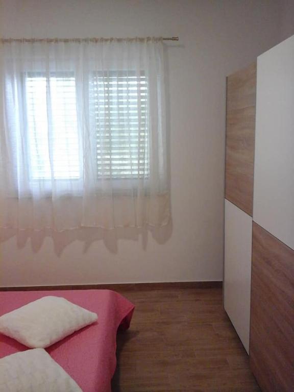 Postel nebo postele na pokoji v ubytování Apartman Krešo i Niko