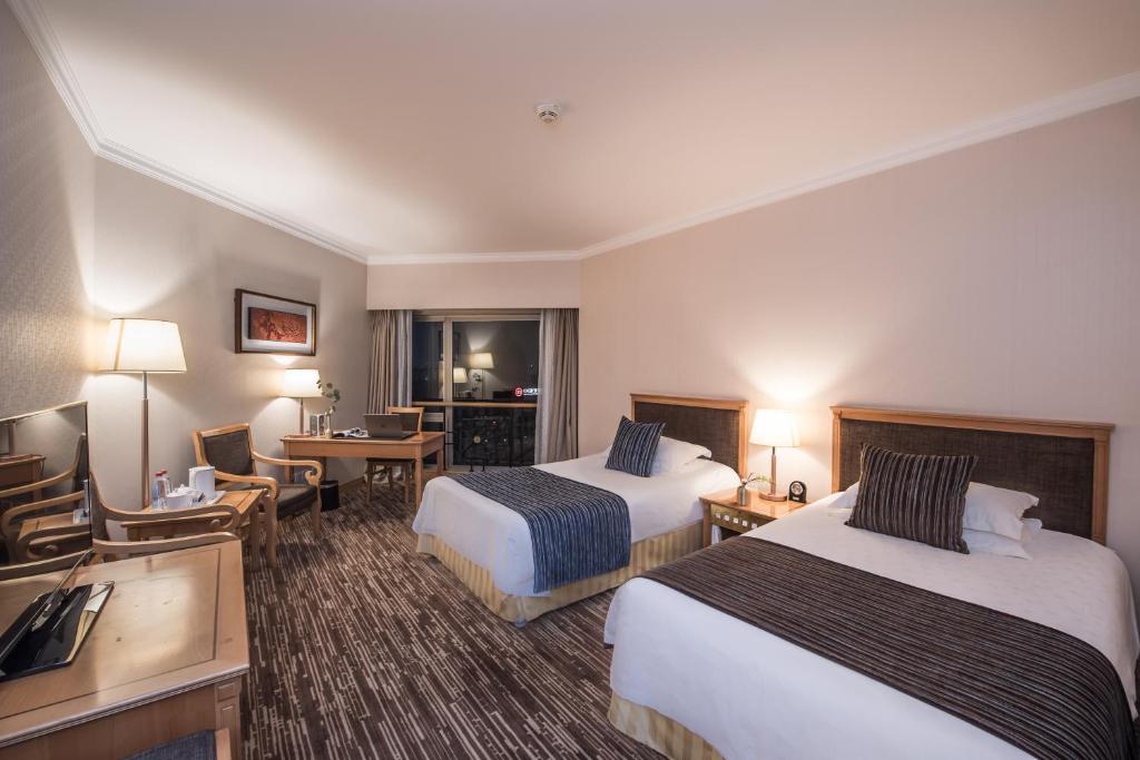 Postel nebo postele na pokoji v ubytování Xiyuan Hotel